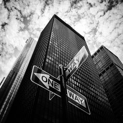 Low angle view of road sign against sky