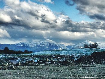 Scenic view of mountains against cloudy sky