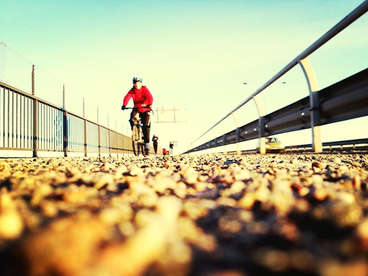 lifestyles, leisure activity, rear view, full length, walking, clear sky, men, standing, person, casual clothing, sky, surface level, railing, copy space, the way forward, day, outdoors