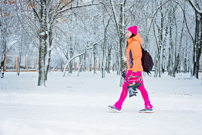 Woman getting ready to winter workout outdoor exercise. winter fitness, exercising in cold weather