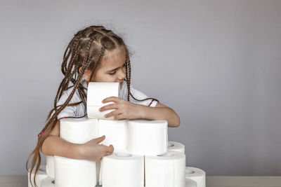 Portrait of girl looking away against wall