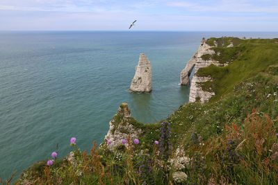 Stack rock in sea against sky