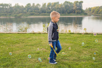 Low section of man standing on field