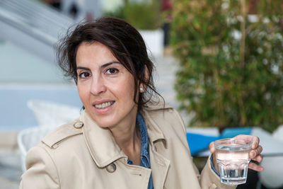 Portrait of woman holding drinking glass