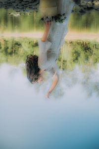 Low section of woman standing in water