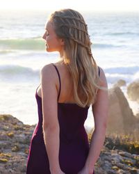 Midsection of woman standing at beach