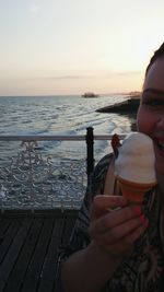 Woman holding umbrella on beach