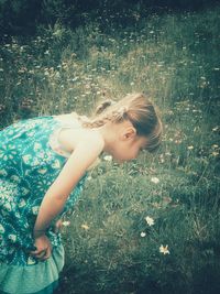 Young woman with flowers on field