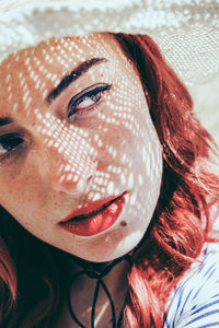 Close-up of young woman wearing hat