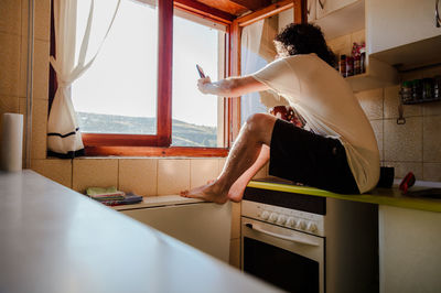 Man sitting by window at home