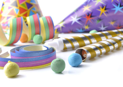 Close-up of multi colored party equipment on white background