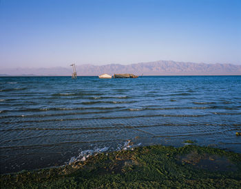 Scenic view of sea against clear blue sky