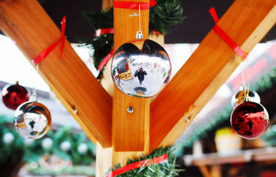 Low angle view of christmas decorations hanging on ceiling at temple