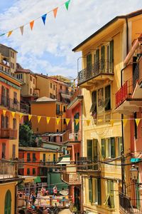 Buntings hanging amidst buildings in city