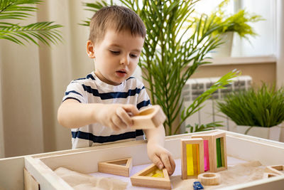 Portrait of cute girl painting on table