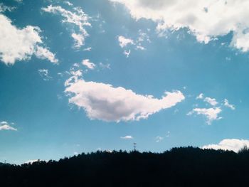 Low angle view of silhouette trees against sky