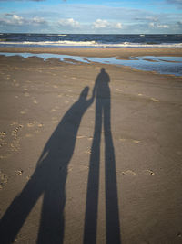 Shadow of people on beach