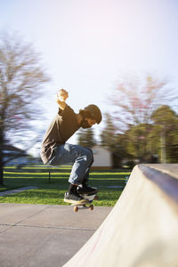 Full length of man skateboarding on skateboard against sky