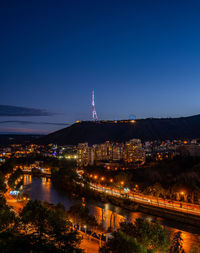 High angle view of illuminated buildings in city at night