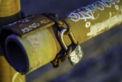 Close-up of padlock hanging on railing