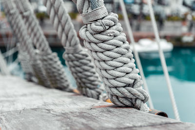 Close-up of rope tied to boat moored at harbor