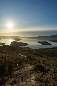 Scenic view of land against sky during sunset conic hill