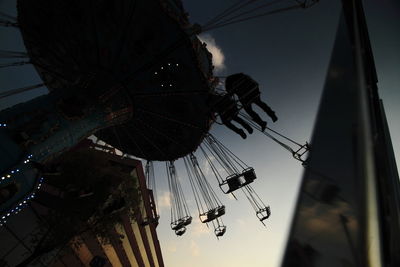Low angle view of amusement park against sky