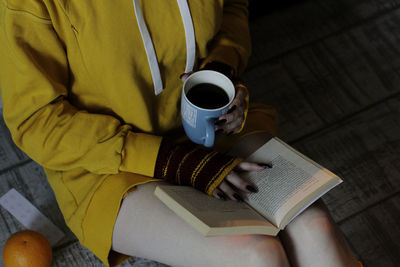 High angle view of coffee cup on book