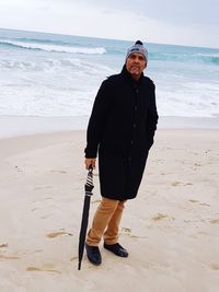 Man standing on beach against sea