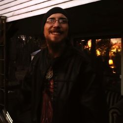 Portrait of smiling young man standing at home