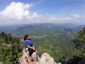 Man looking at mountains against sky