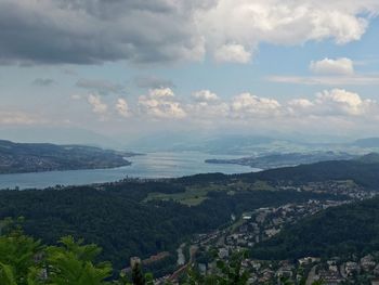 Scenic view of landscape and sea against sky