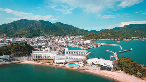 High angle view of sea and mountains against sky