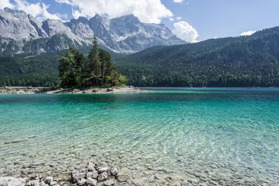 Scenic view of sea and mountains against sky