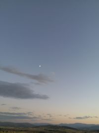 Low angle view of moon at sunset