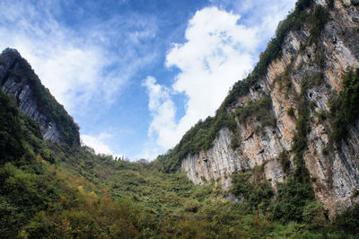 Low angle view of rocky mountains against sky