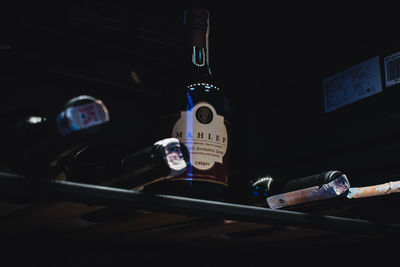 High angle portrait of man holding bottle on table