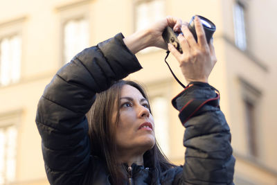 Portrait of photographer woman unfocused background at florence, italy. 50mm lens