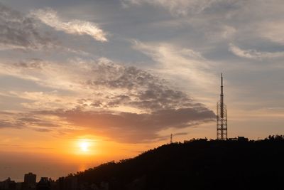Low angle view of silhouette tower against sky during sunset