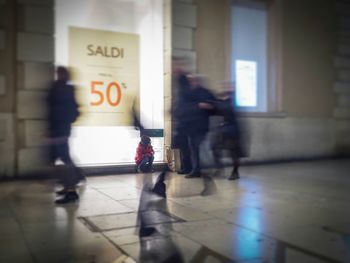 Blurred motion of woman walking on road