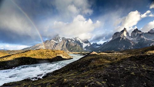 Scenic view of mountains against cloudy sky