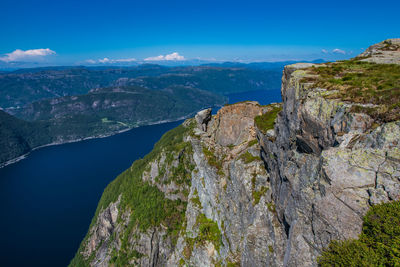 Scenic view of mountains against blue sky