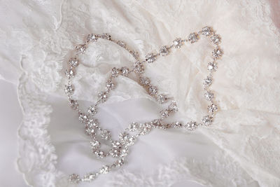 Close-up of necklace on wedding dress