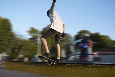 Portrait of skateboarder sliding in a gap