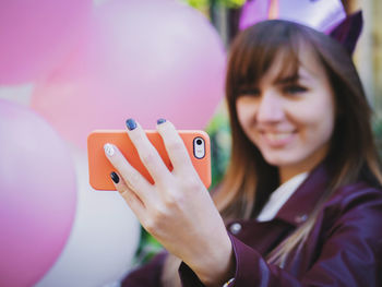 Smiling young woman taking selfie