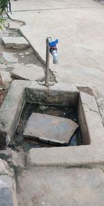 High angle view of faucet on footpath