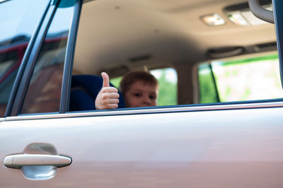 Portrait of man seen through car window