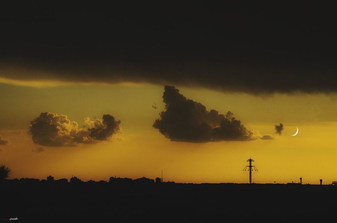 SILHOUETTE OF HOT AIR BALLOON AGAINST SKY