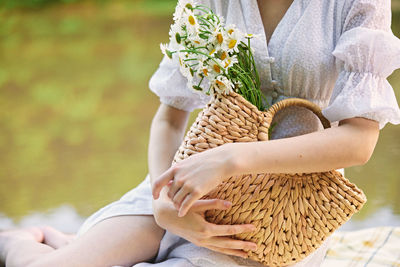 Midsection of woman holding bouquet