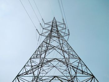 Low angle view of electricity pylon against clear sky